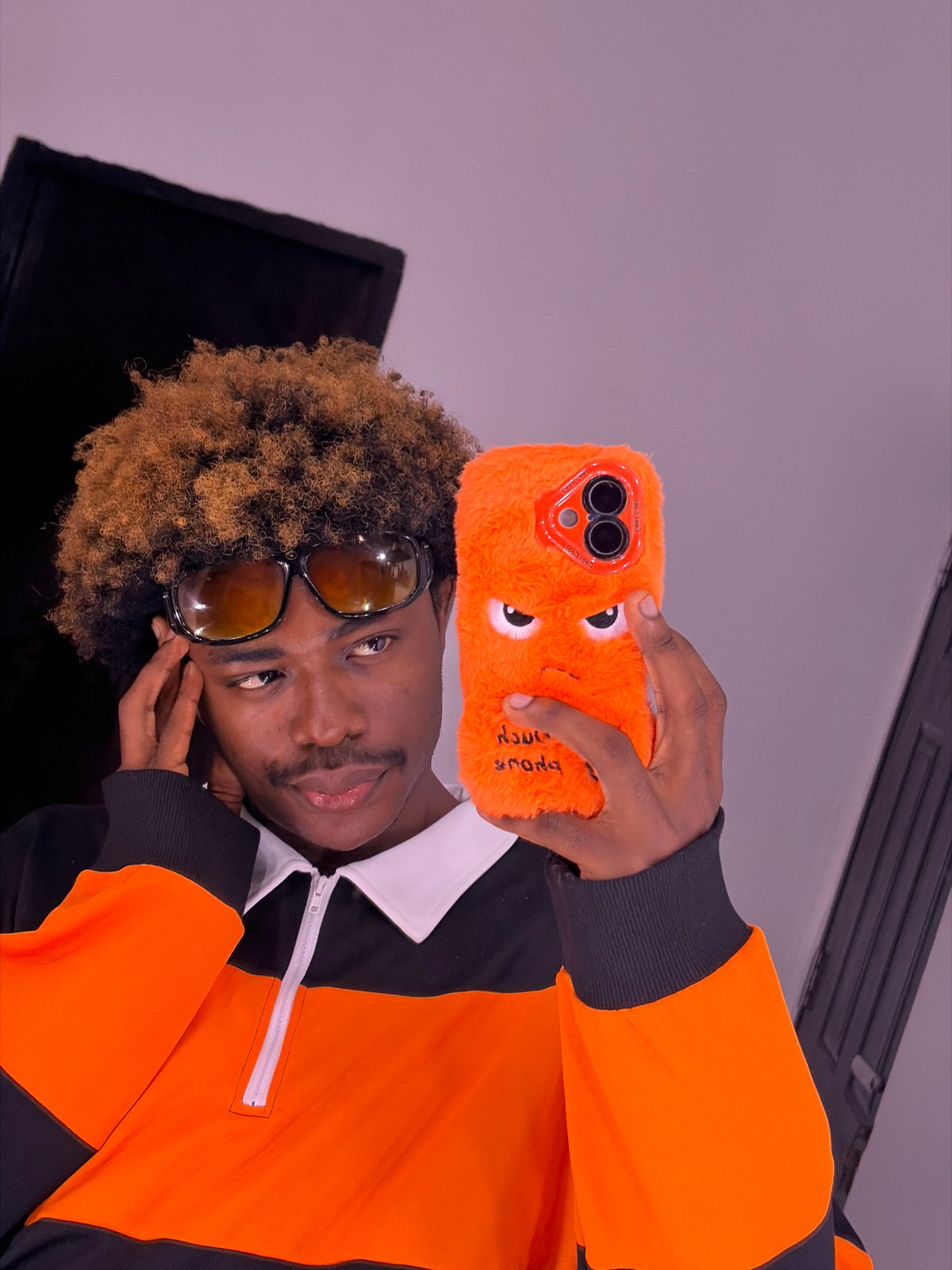 Man displays novelty phone case in Igboefon, Nigeria
