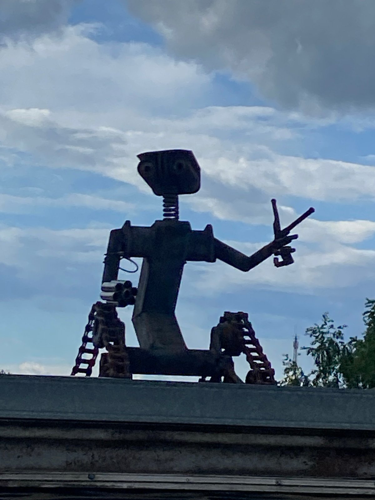 Garden walk with flowers and robot sculpture documented in Фоки