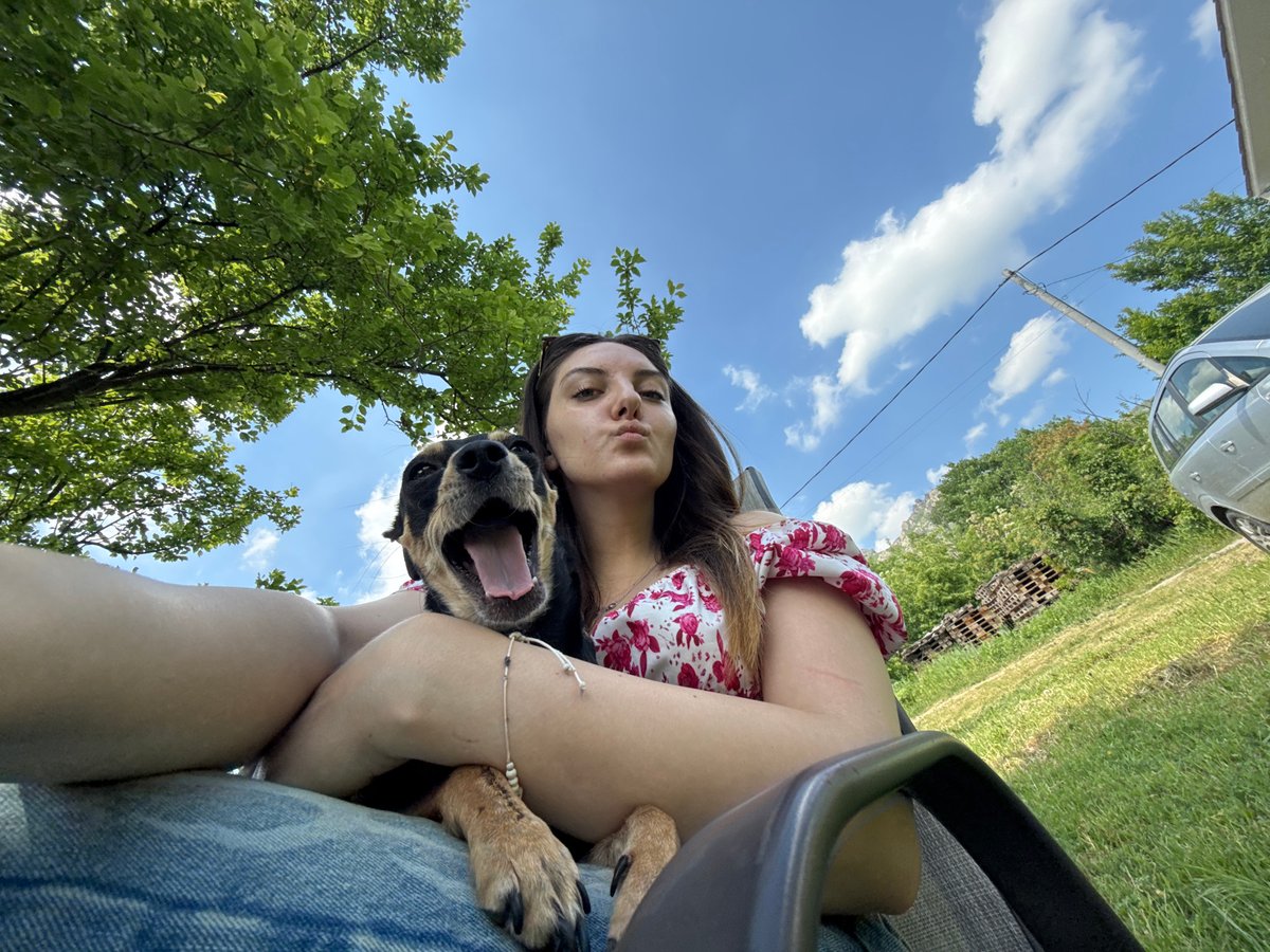 Woman relaxes with dog during outdoor afternoon in Bulgaria