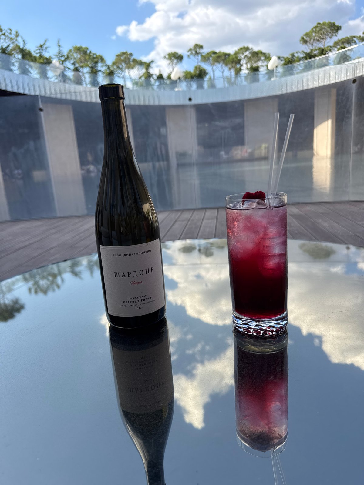 Drinks at a poolside venue with a dramatic waterfall backdrop