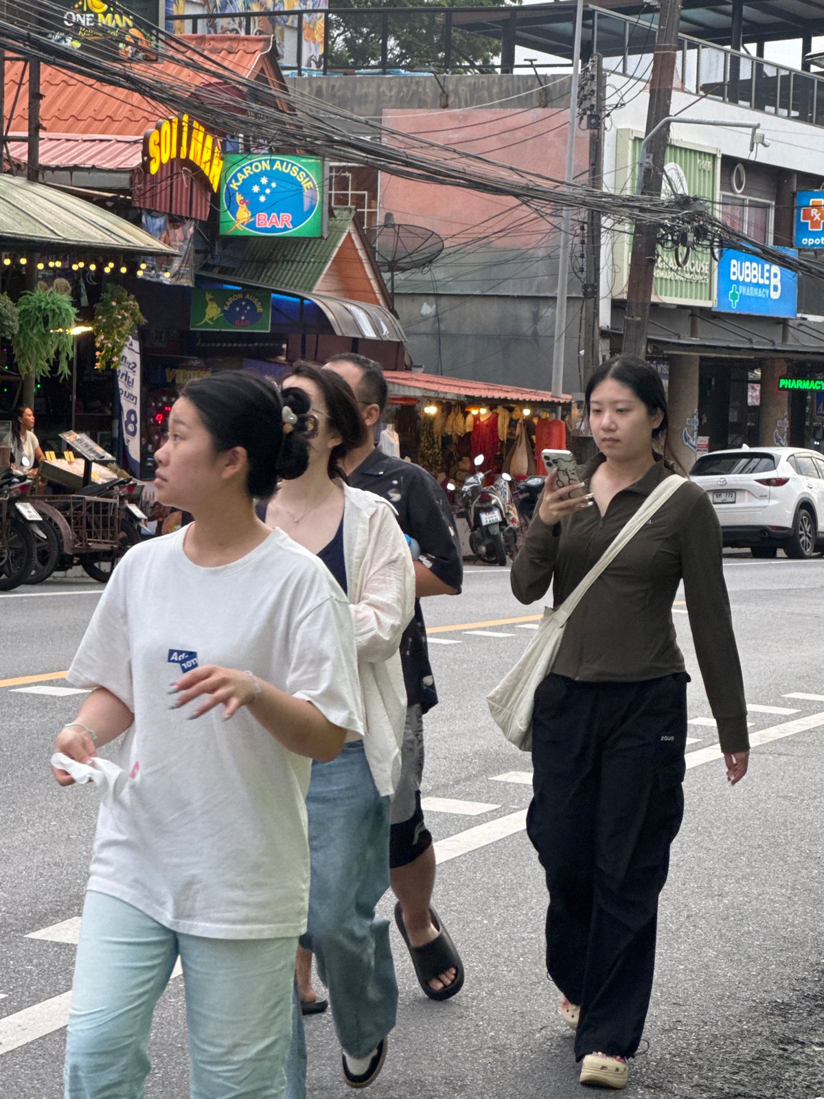 Karon street scene: shops, traffic, and foot traffic on a grey afternoon