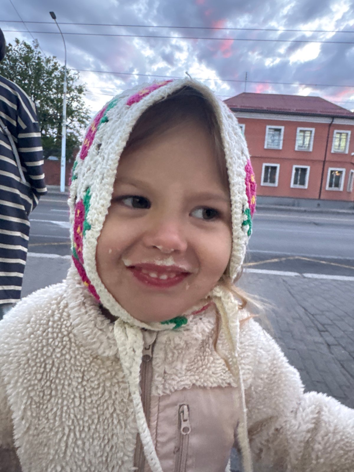 Child and residential building photographed in Kaliningrad evening
