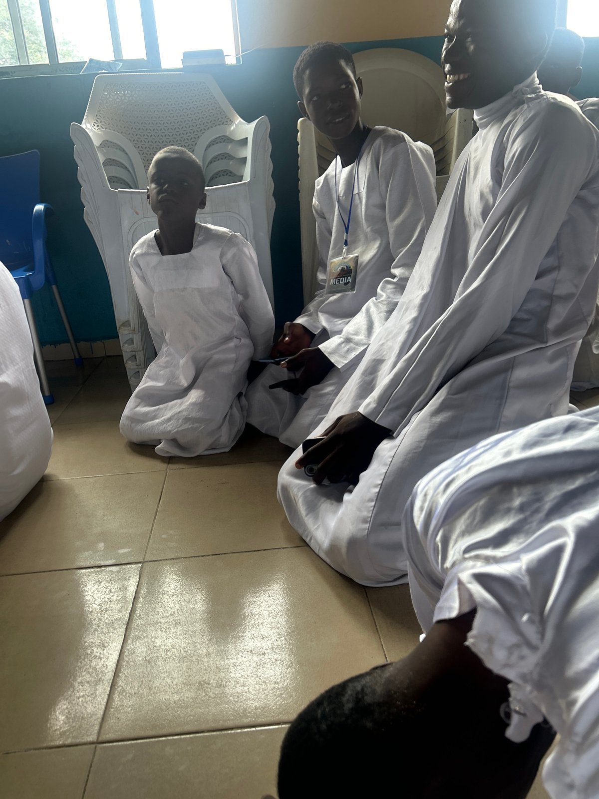 White-robed gathering documented in Adankolo indoor space