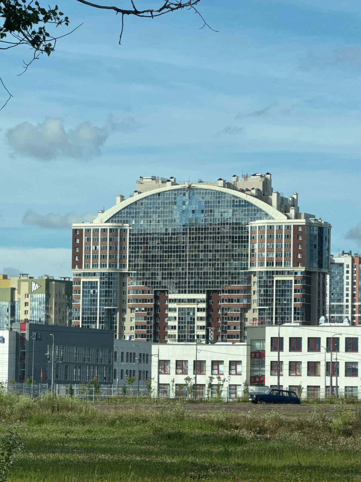 Curved glass residential tower in a new Saint Petersburg development