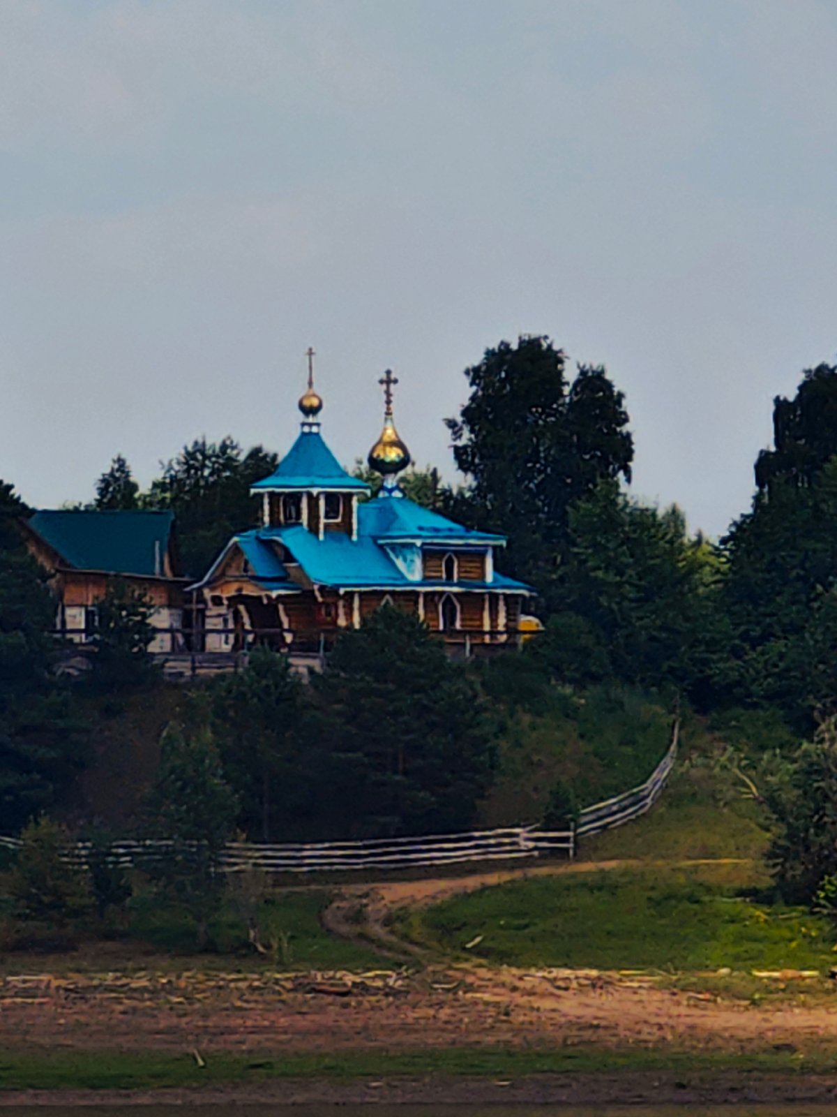 Wooden Orthodox church and river life in rural Siberia