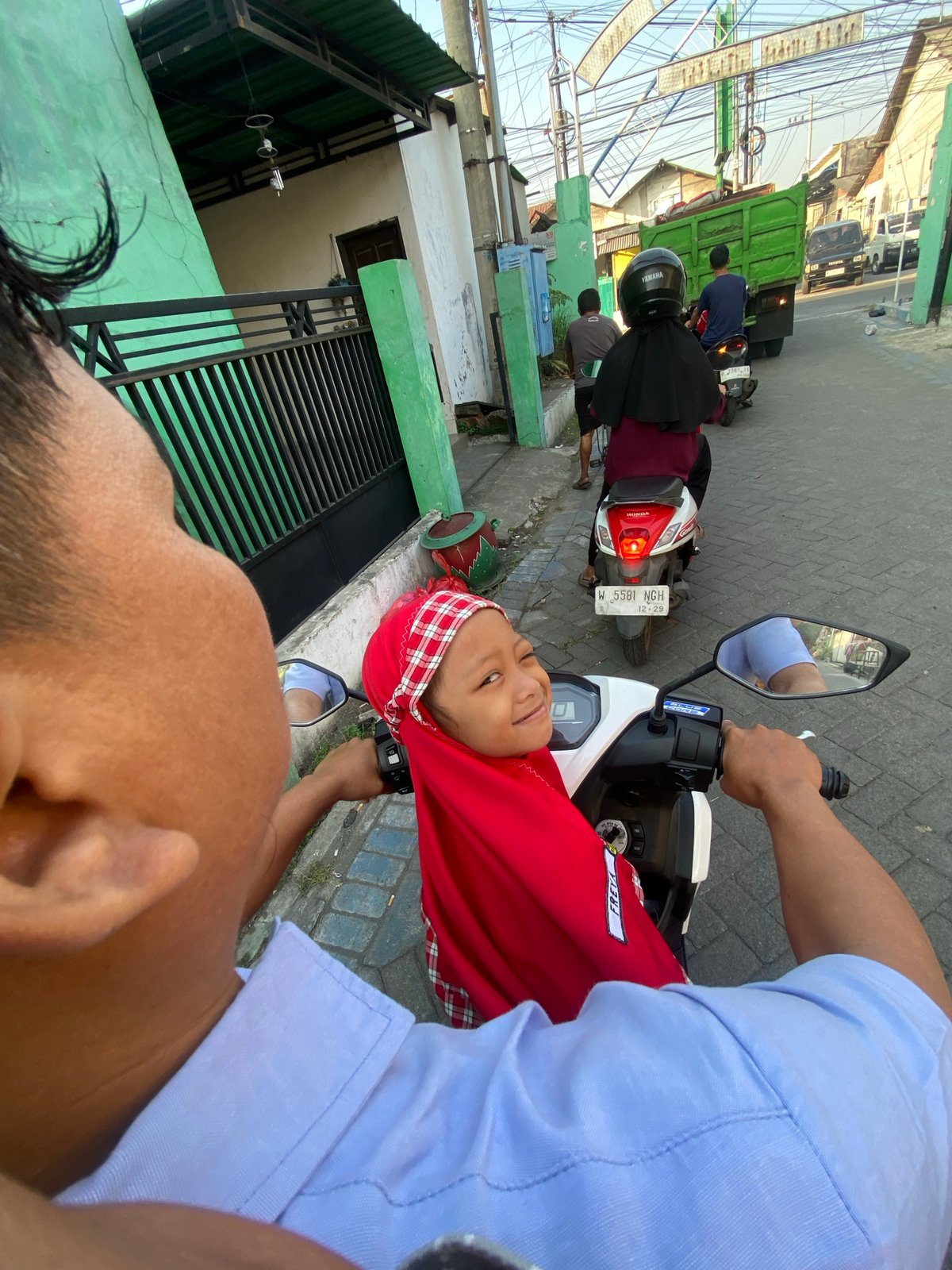 Evening motorcycle rides captured across two Indonesian villages