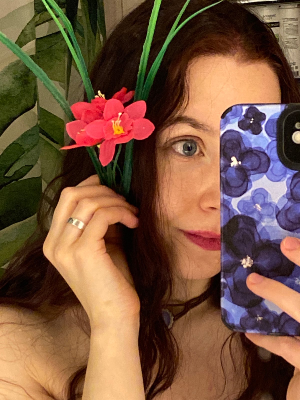 Woman poses with white flower in Chaikovsky bedroom