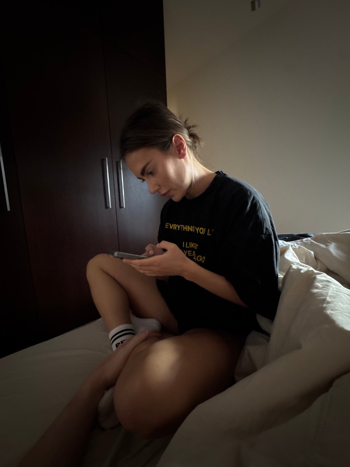 Person uses phone in Warsaw bedroom
