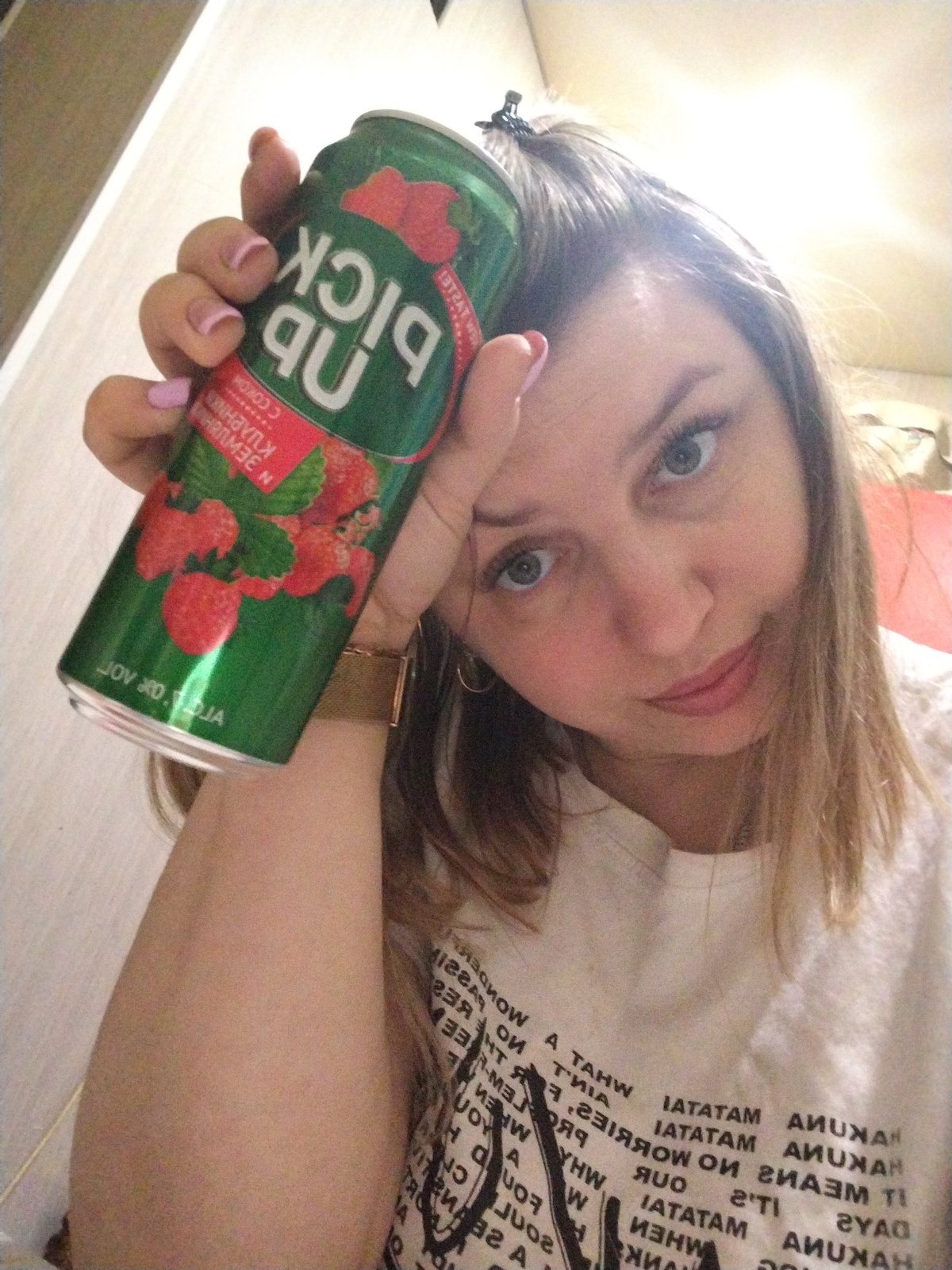 Woman takes selfie with green beverage in Yaroslavl