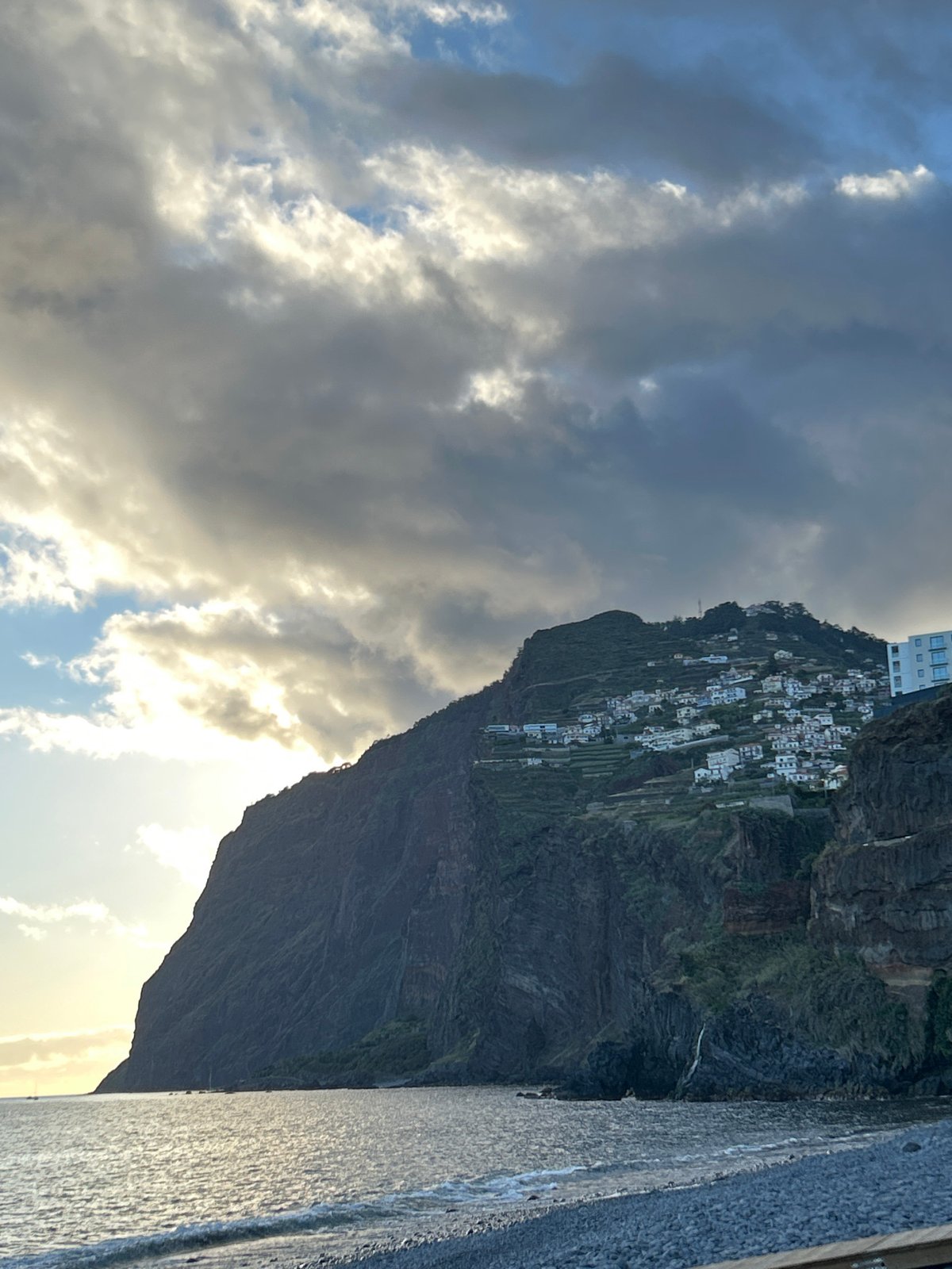 Terraced cliffs and white buildings captured in Câmara de Lobos