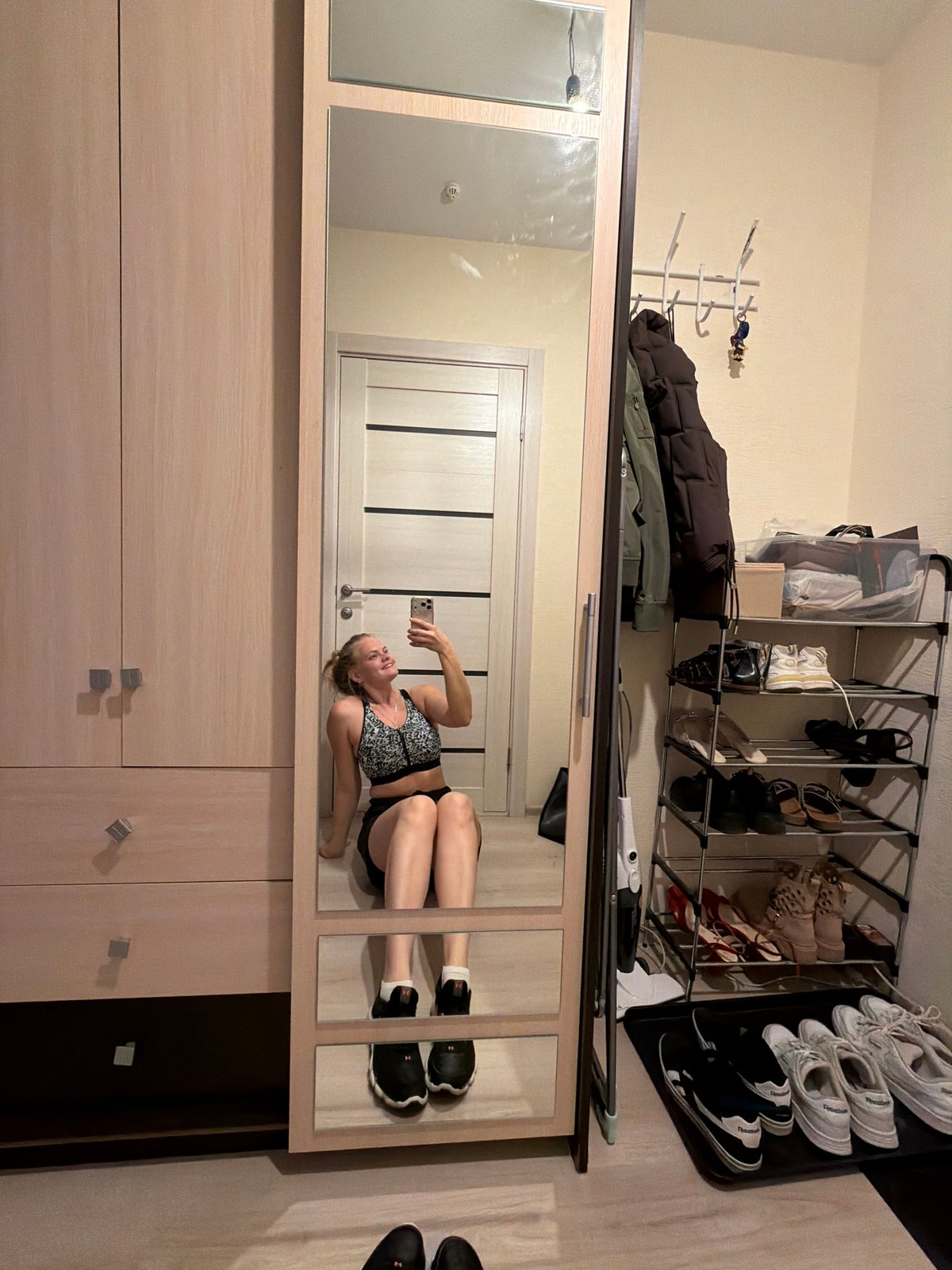 Woman documents mirror selfie session in Izhevsk apartment