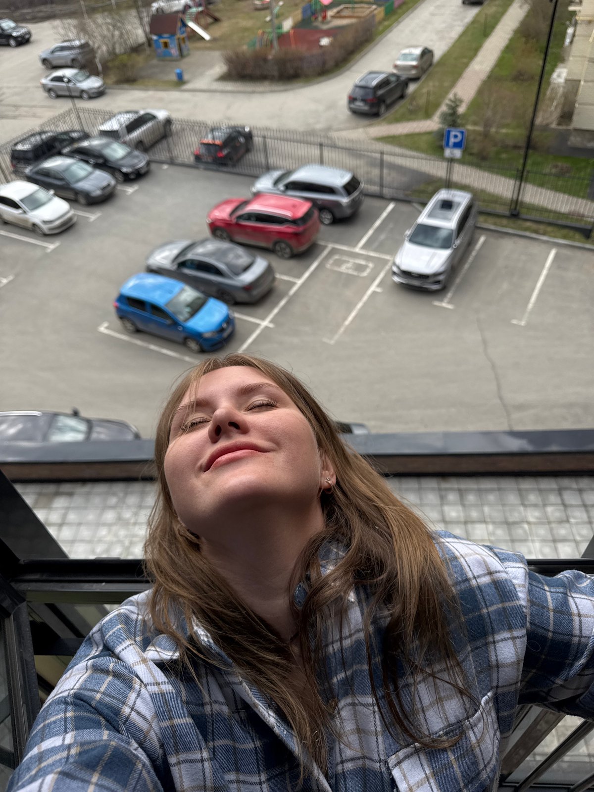 Woman leans from building window in Perm, Russia