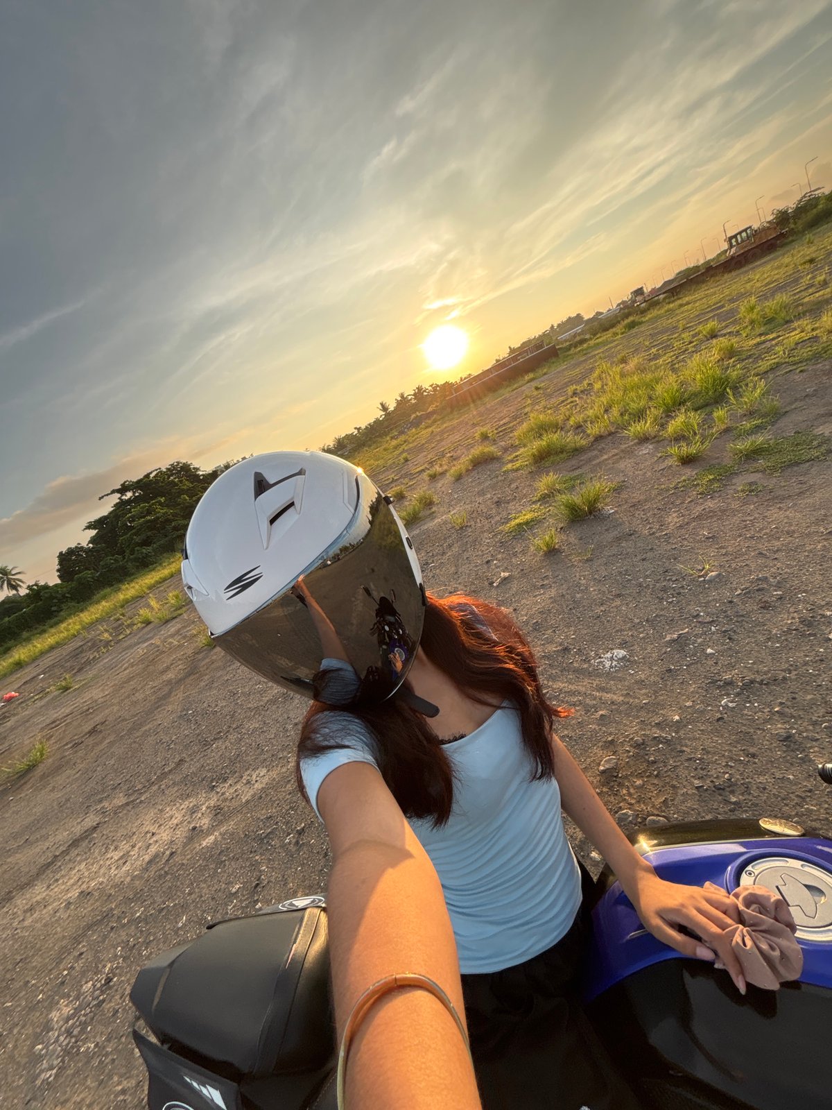 Young woman takes sunset selfies at Davao City pier
