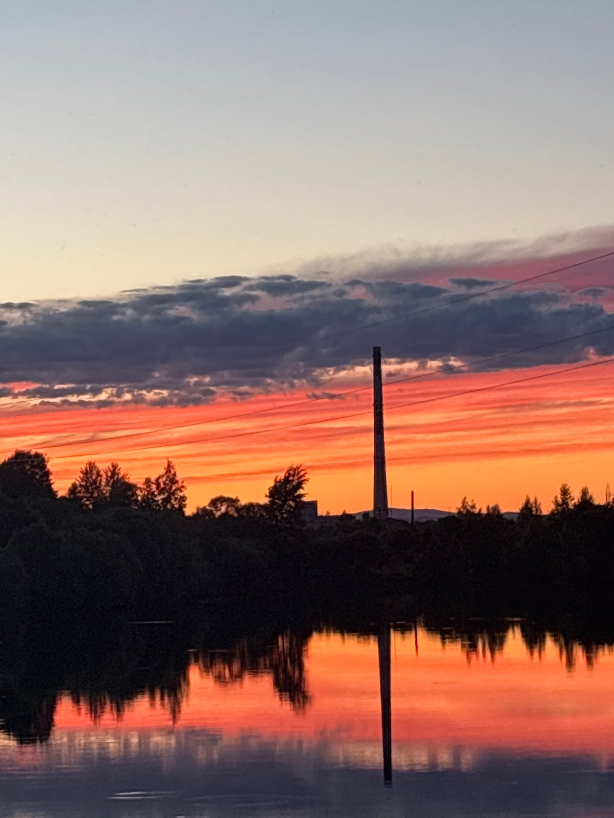 Sunset over Birobidzhan with parked car and power infrastructure