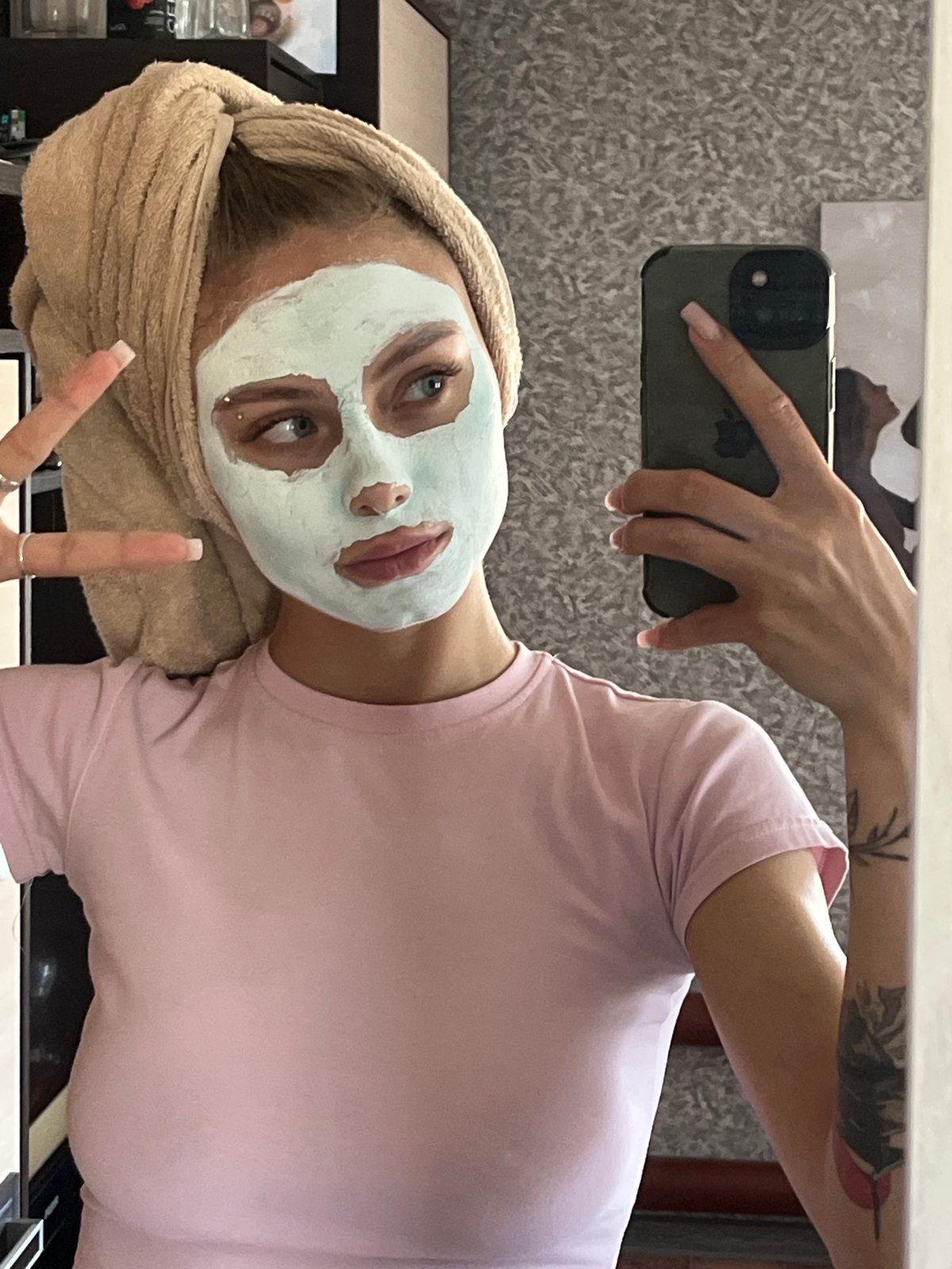 Woman documents morning skincare routine with facial mask in Russia