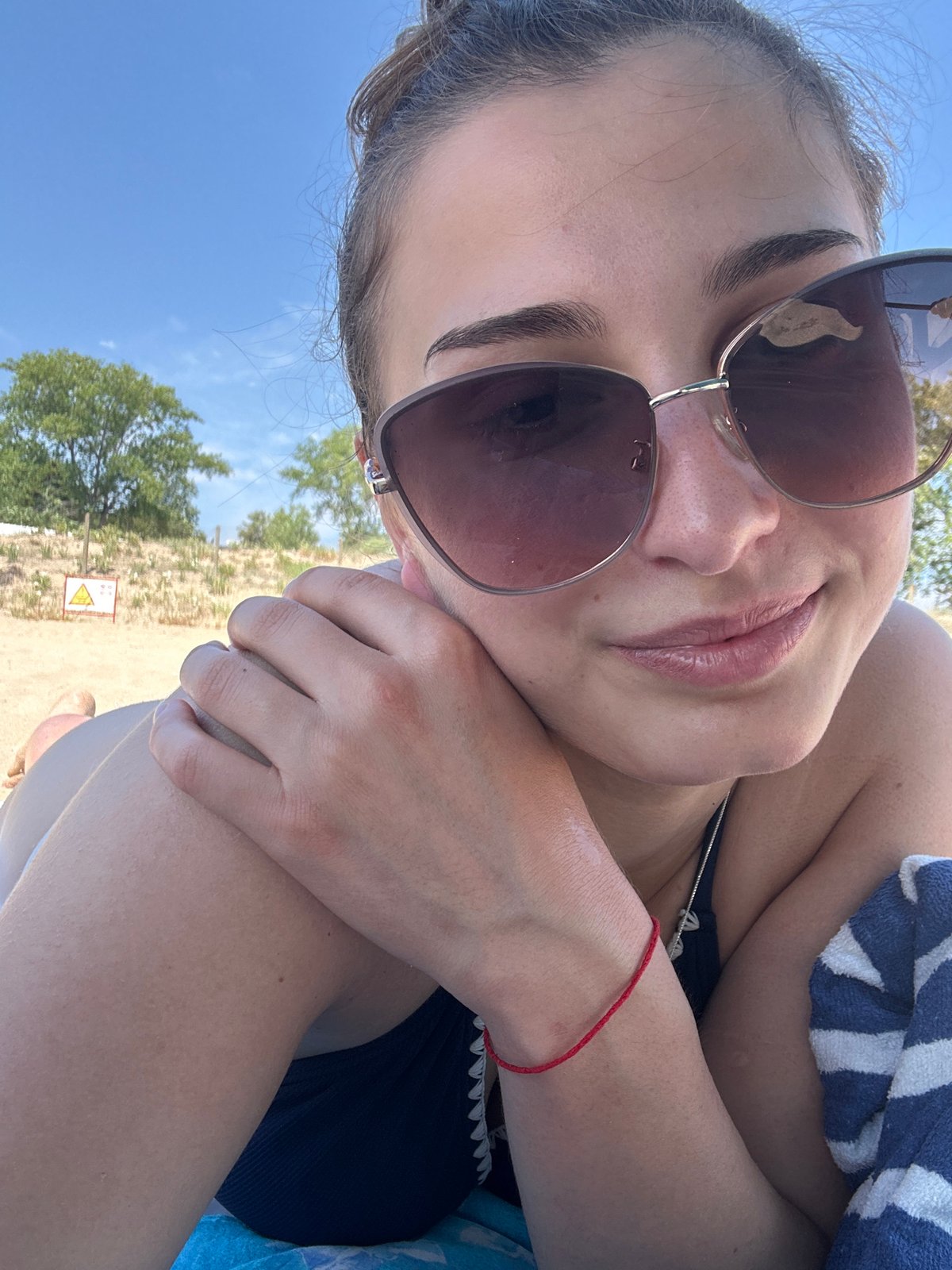 Lazy morning on the beach, sunglasses and sand.