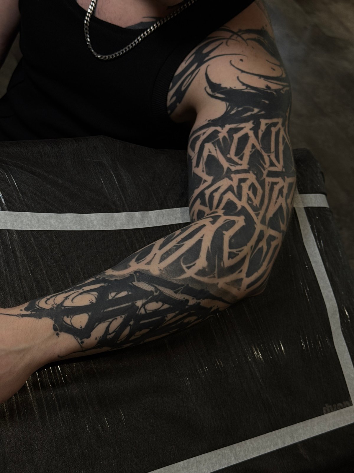 Person displays geometric black tattoo in Moscow