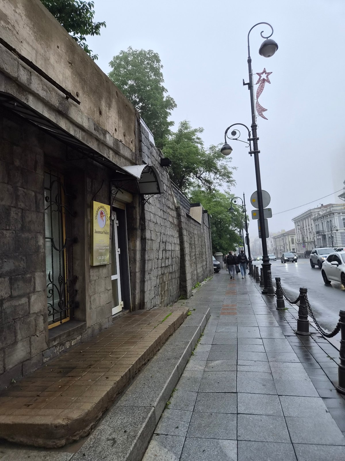 Wet streets and city details in Vladivostok on a grey day