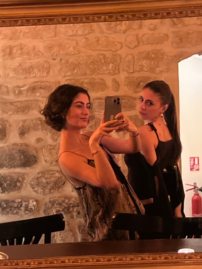 Women document evening dining experience at Paris restaurant