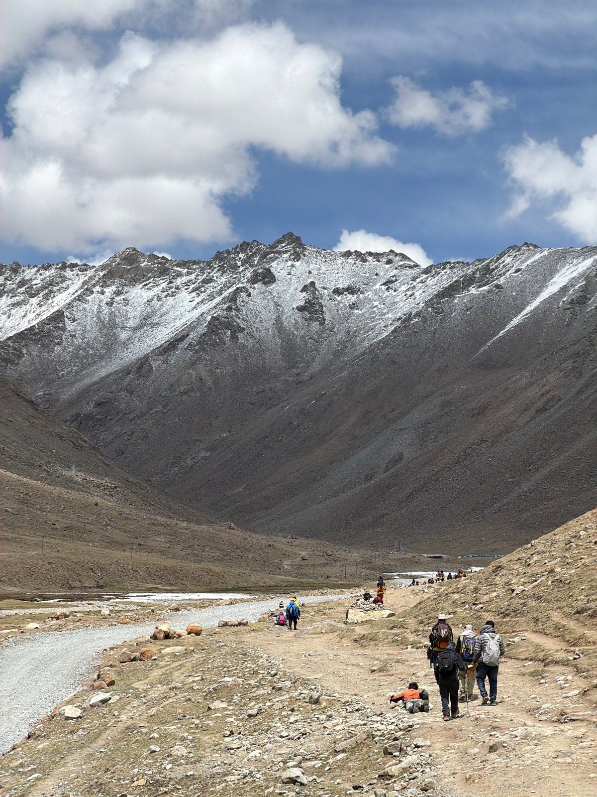Mountain travelers with pack animals traverse rocky path in China