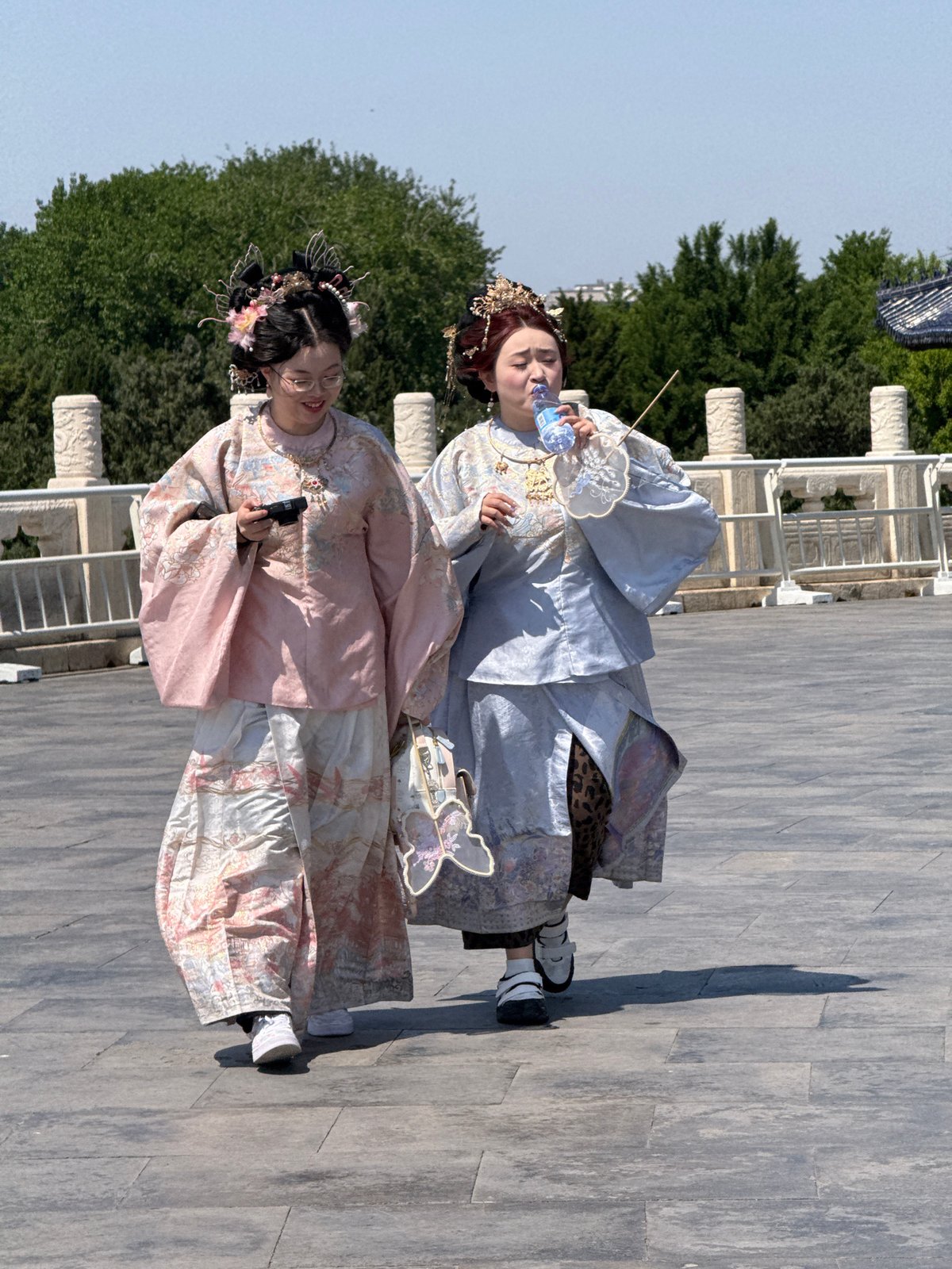 Two people in traditional dress spotted on Beijing walkway
