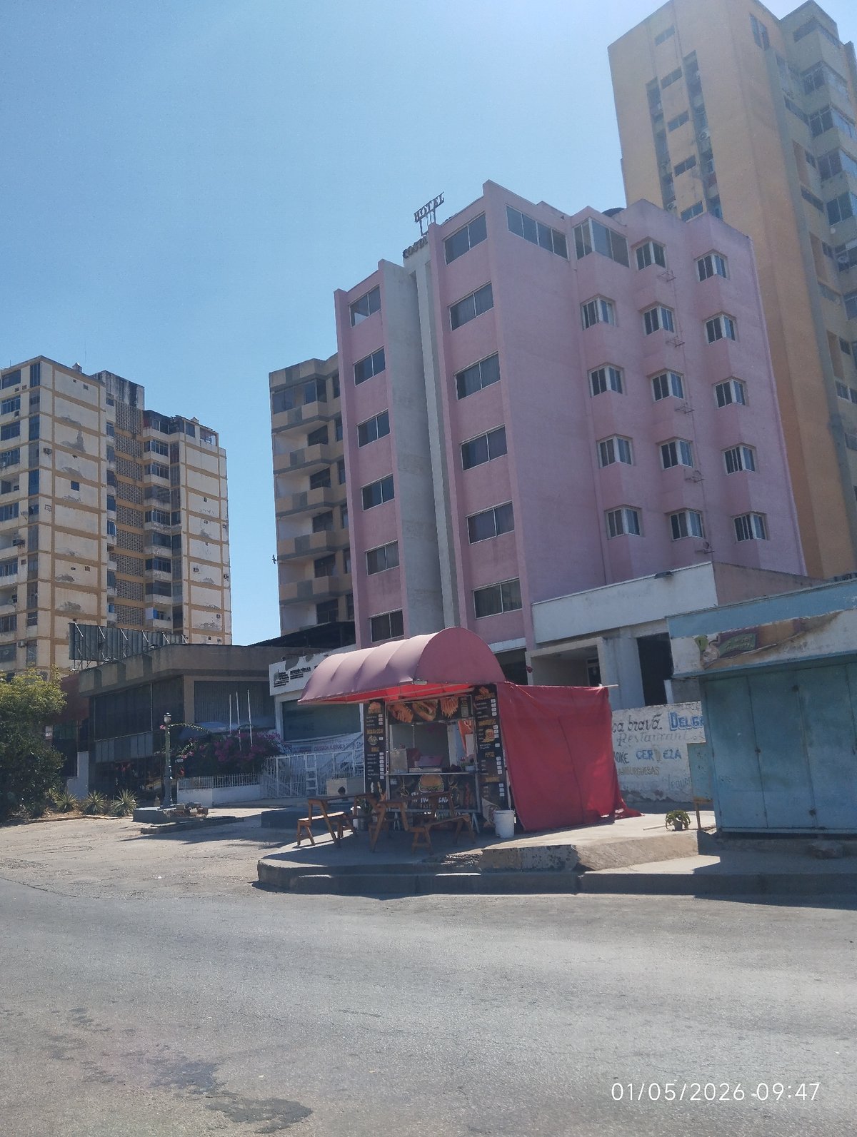 Street food vendor operates sidewalk stand in Porlamar, Venezuela