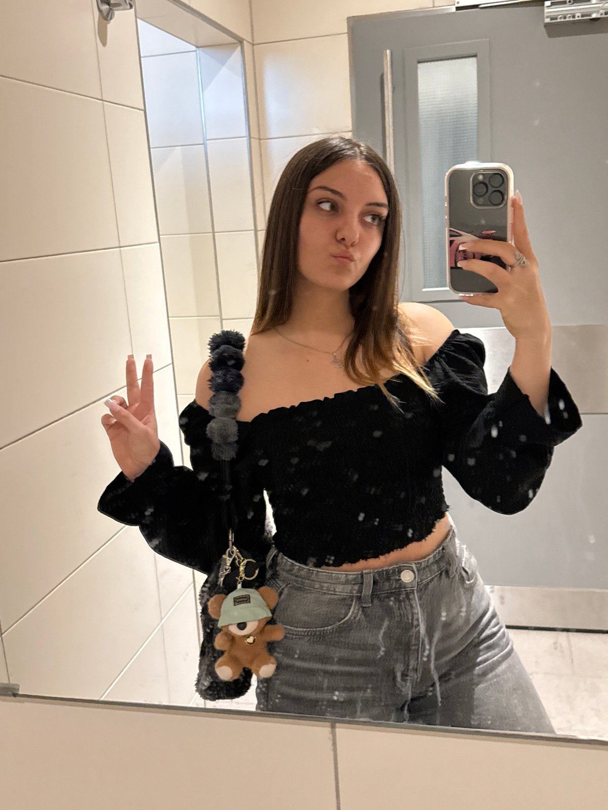 Woman takes mirror selfie in Sofia public facility