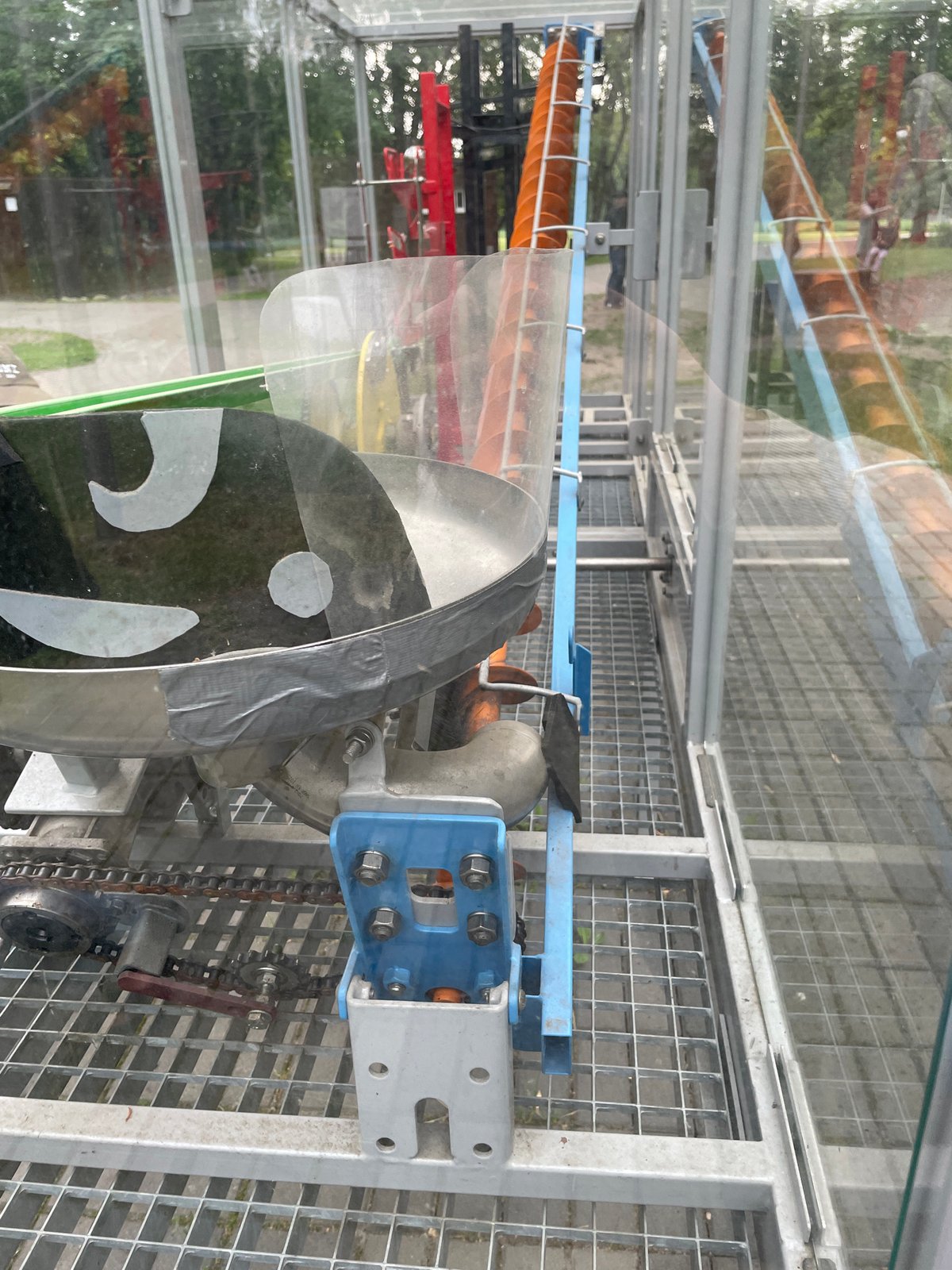 Families explore interactive science exhibits at outdoor educational facility