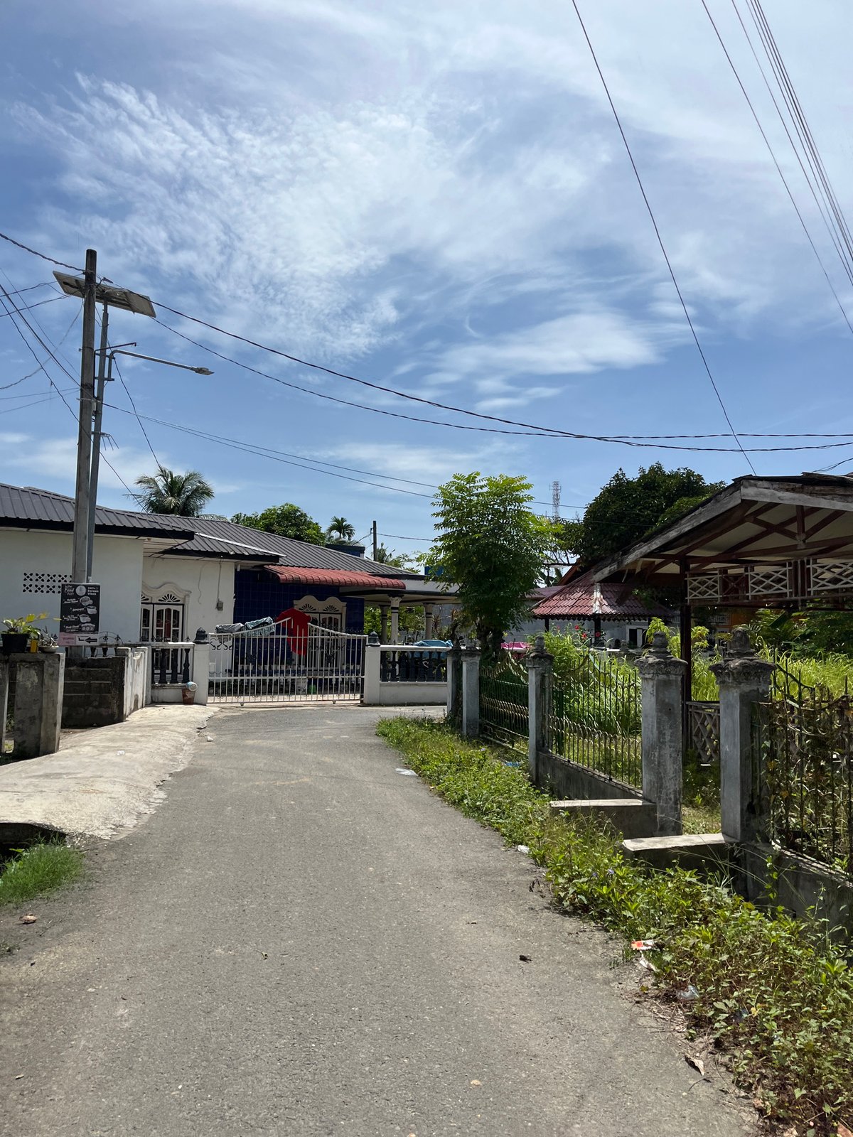 Cruising through Langsa's quiet residential streets on a sunny morning