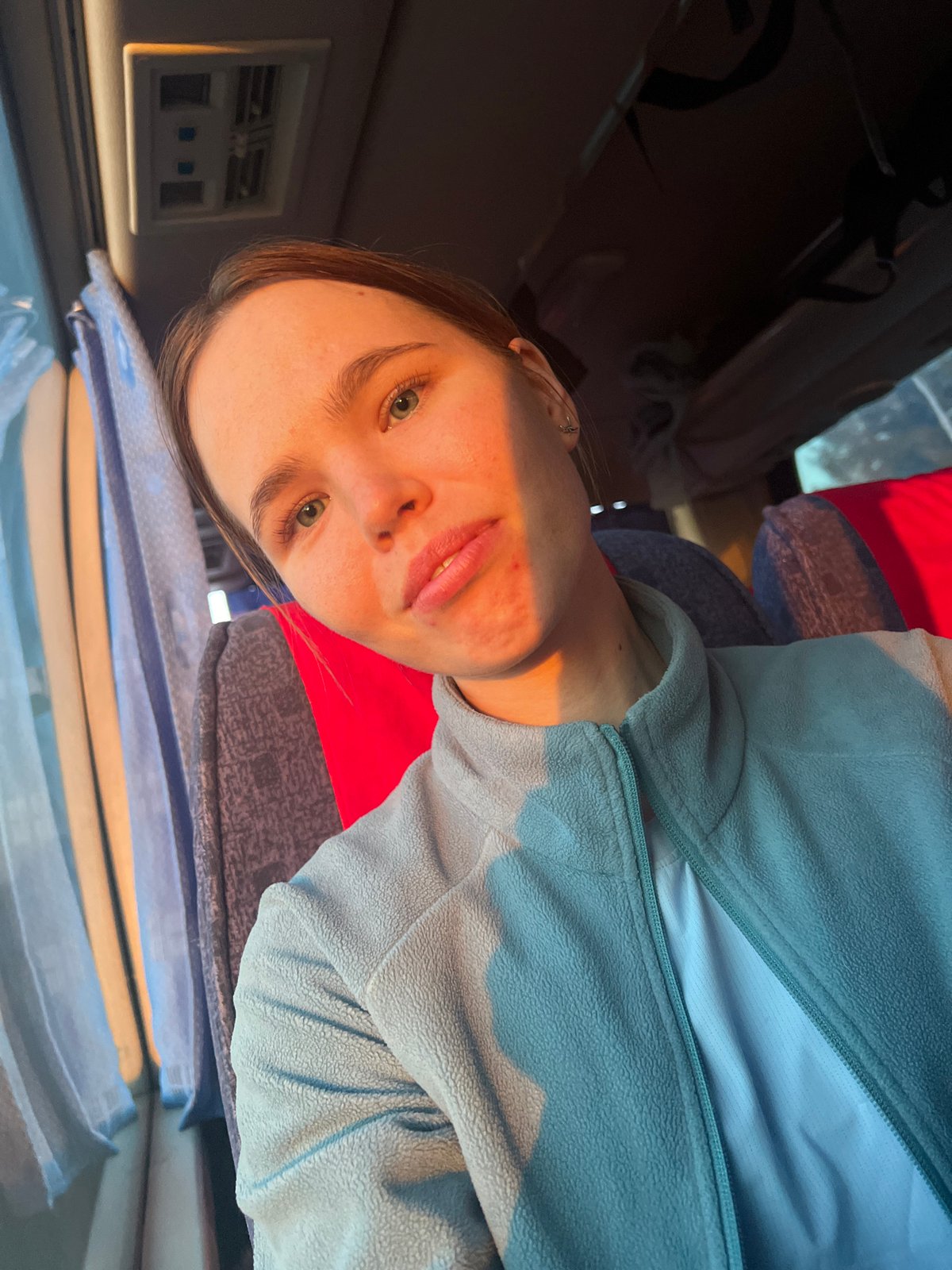 Woman takes selfies in vehicle interior in Ustinovo, Russia