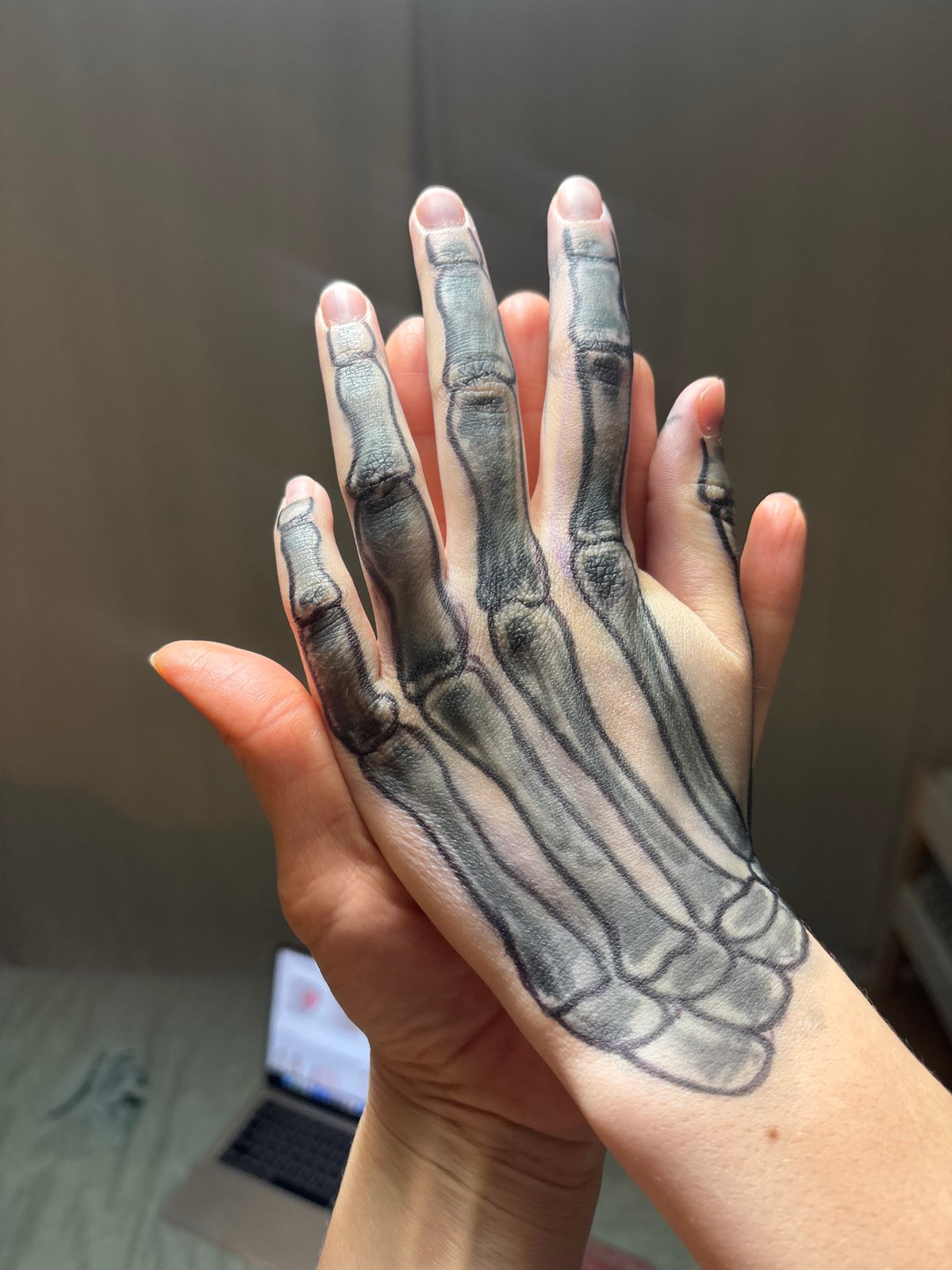 Woman displays skeleton hand art in Chaikovsky, Russia