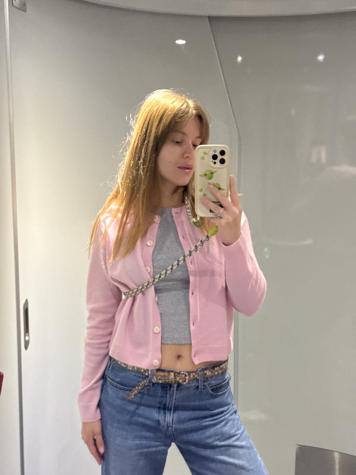 Woman takes mirror selfies in public restroom