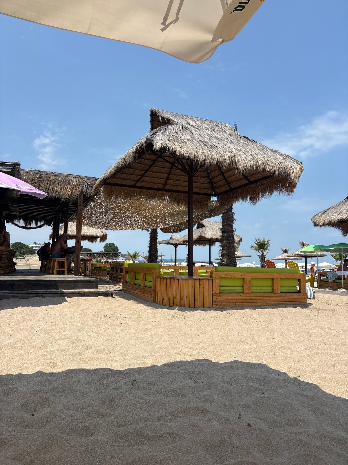 Sunny beach with a striking shadow across the sand