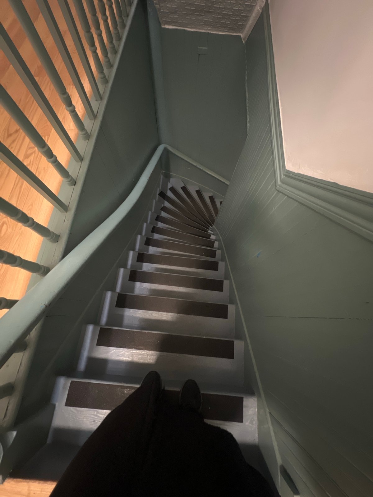 Interior staircase with green walls photographed in New York