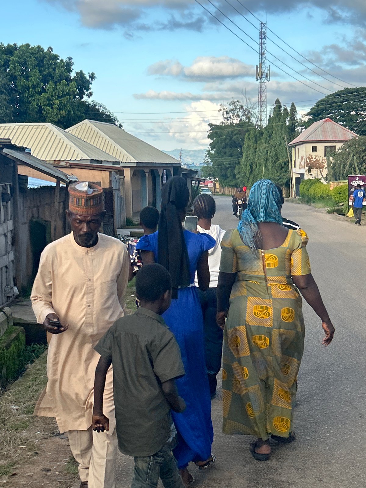 Everyday street life in Jos on a cloudy evening