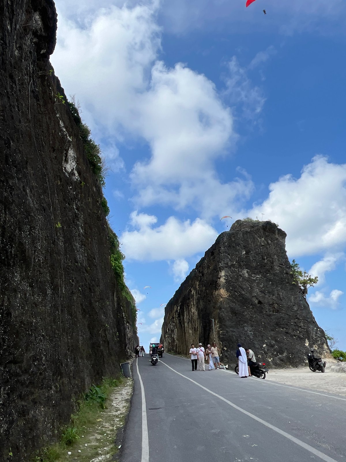 Paragliders swarm the cliffs and coastline of Kuta Selatan