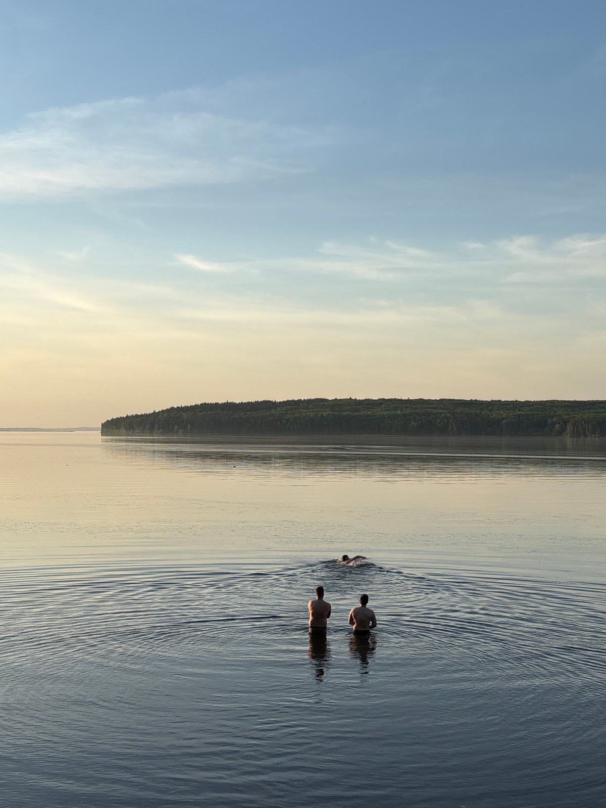 Swimmers enjoy calm waters near Chaikovsky, Russia