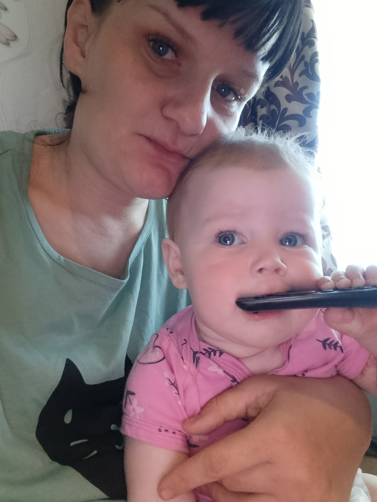 Woman and baby photographed in indoor setting in Фоки, Russia