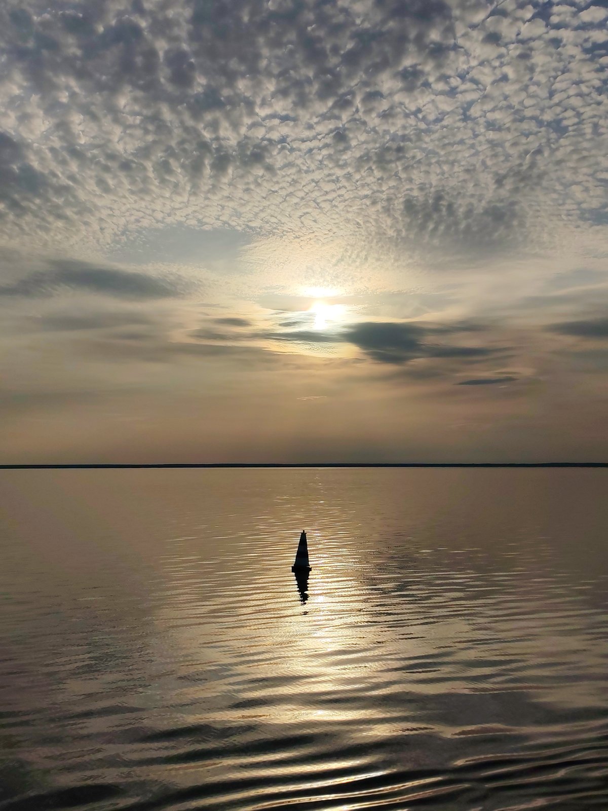 Dark buoy spotted in Russian waters under cloudy skies
