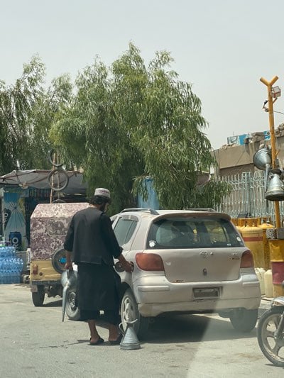 Roadside refueling at informal gas station in Kandahar