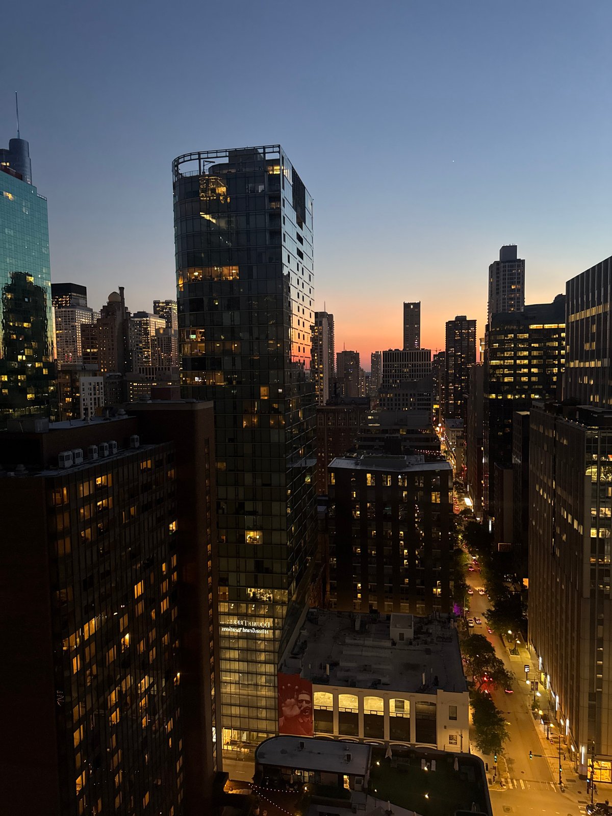 Chicago skyline at dusk, golden hour fading over the city