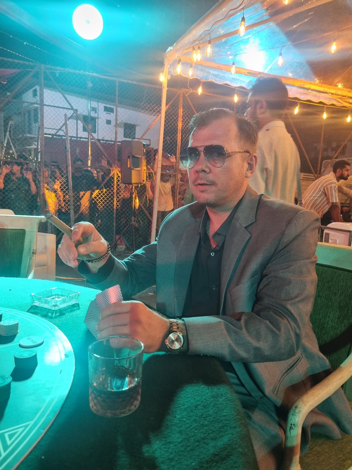 Man photographed in artificial lighting during evening hours
