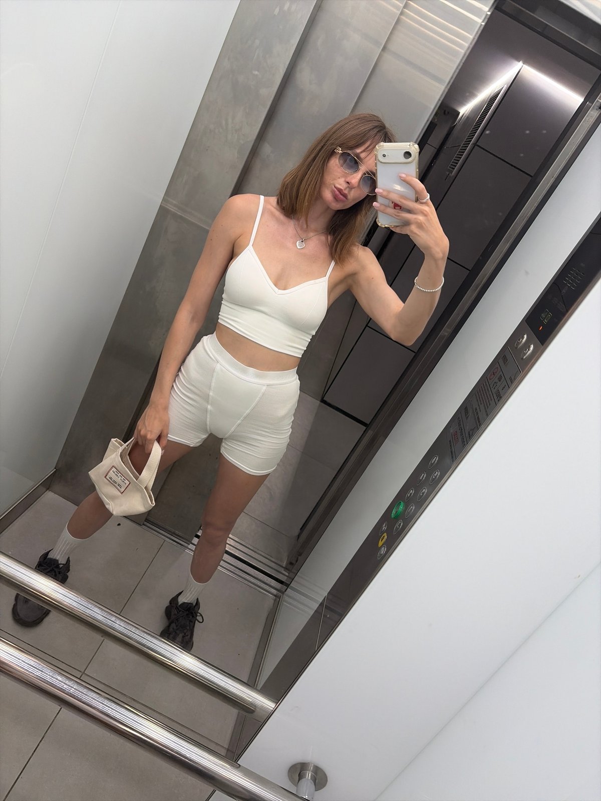 Elevator mirror selfie in athletic wear, Tel Aviv