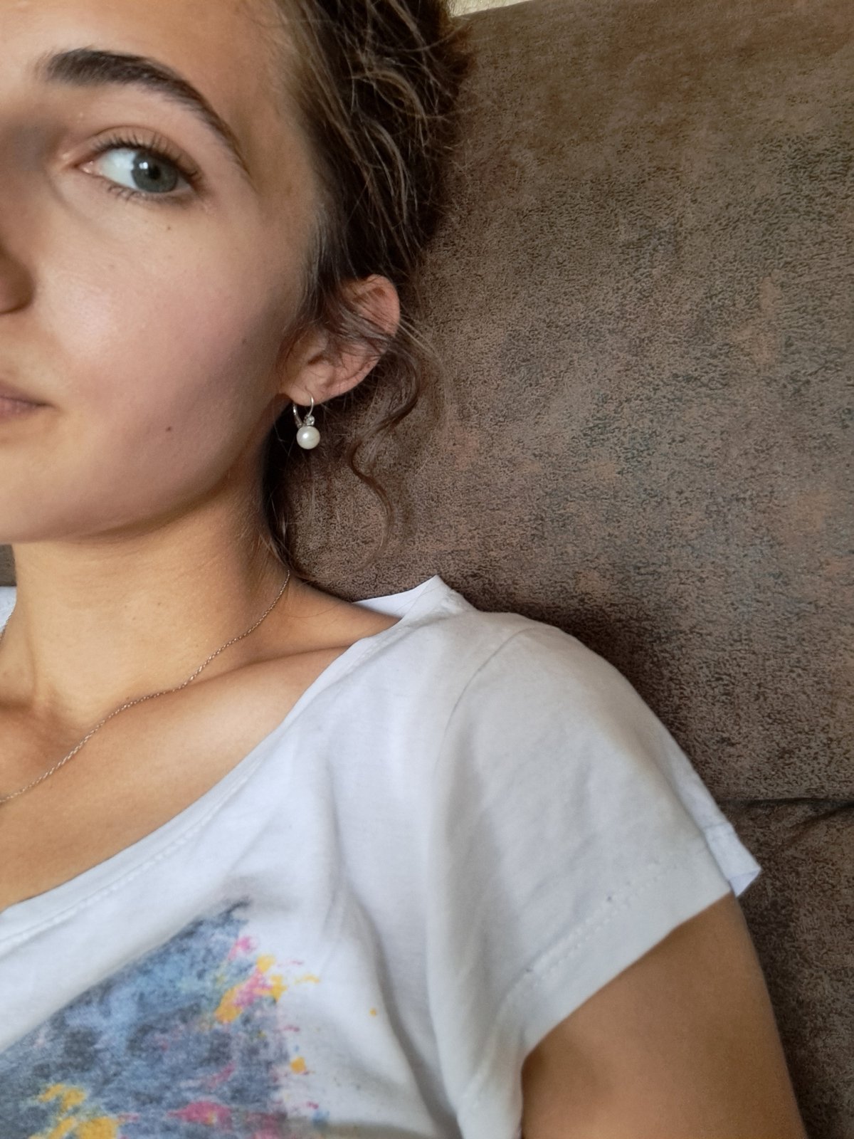 Woman relaxes with drink on couch in Bulgarian home