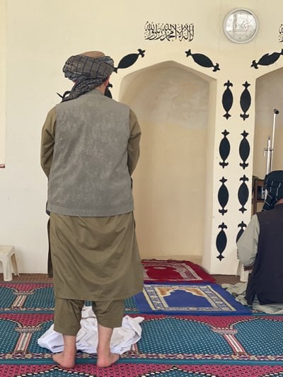 Men in traditional dress observed at Kandahar mosque