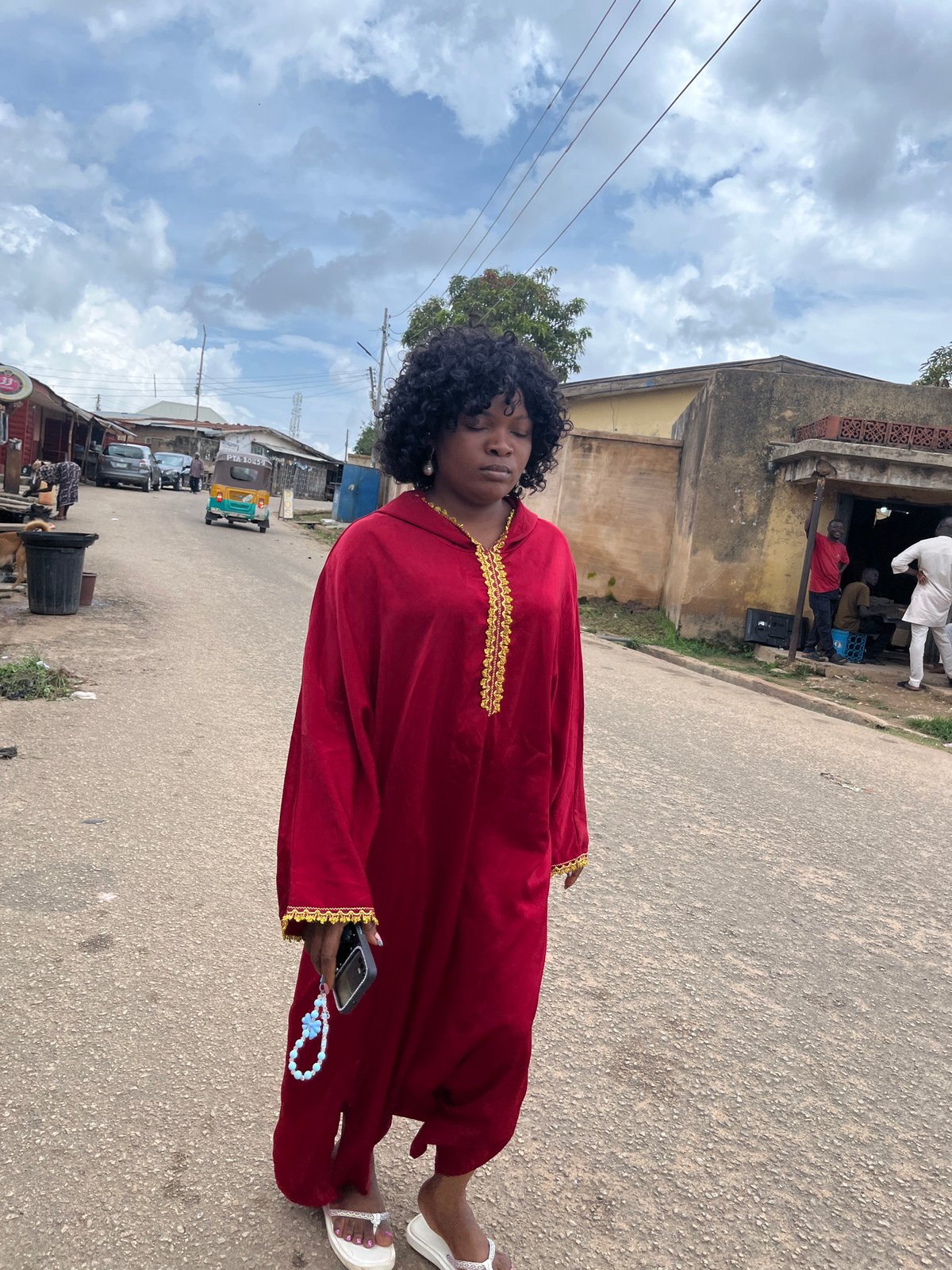 Midday street life in Jos: students, cars, and daily movement