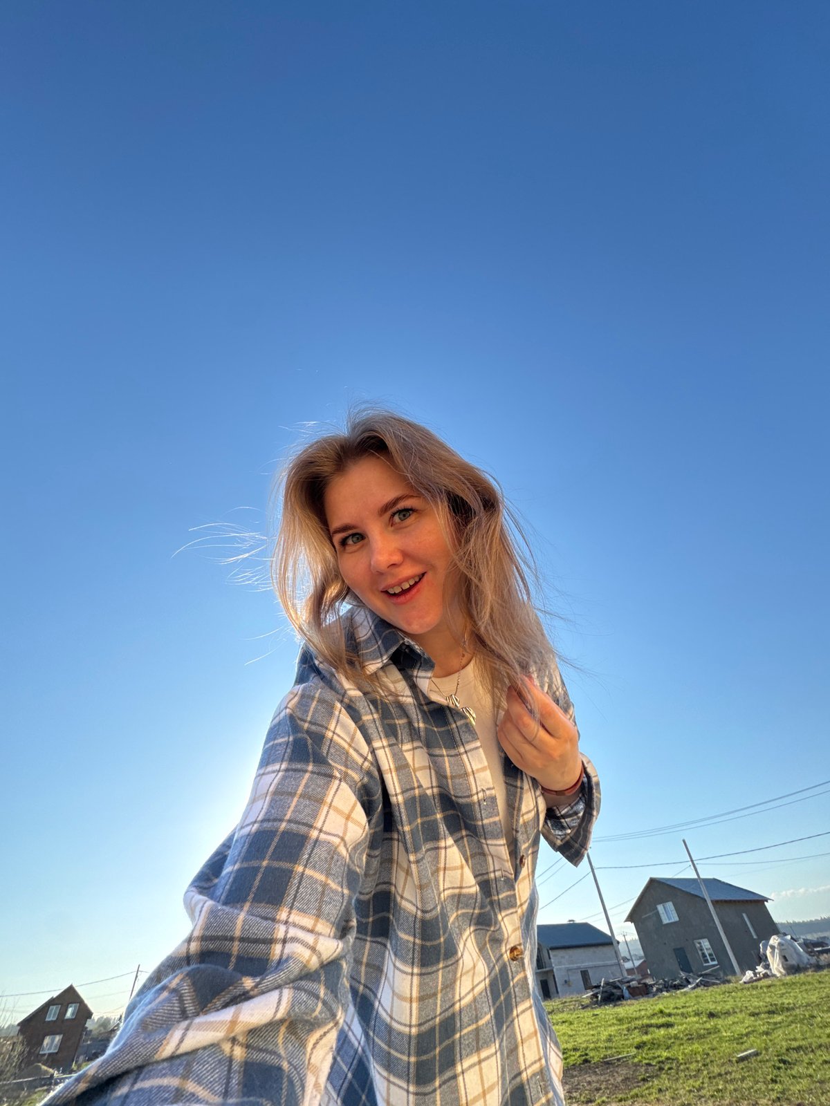 Woman takes outdoor selfies in rural Russian village