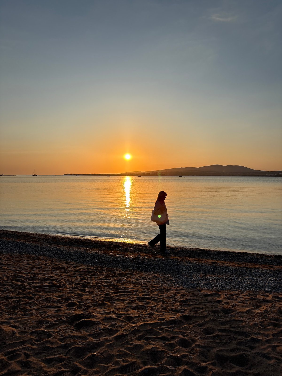 Golden hour sunset draws observers to Gelendzhik beach
