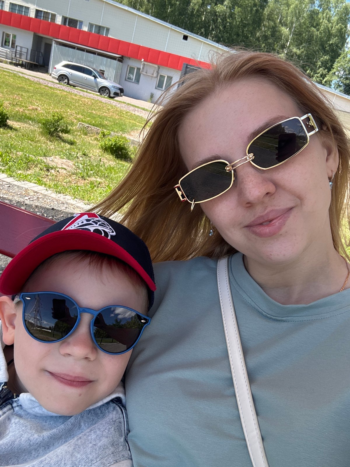 Woman and child pose for photo on sunny day