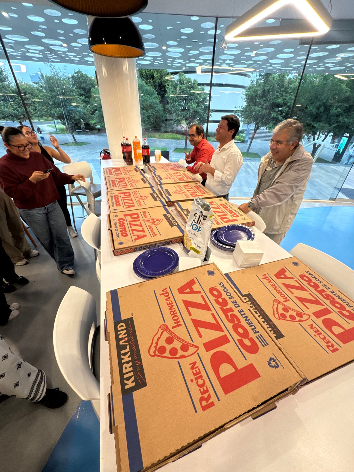 Office pizza gathering documented in Puebla, Mexico evening event